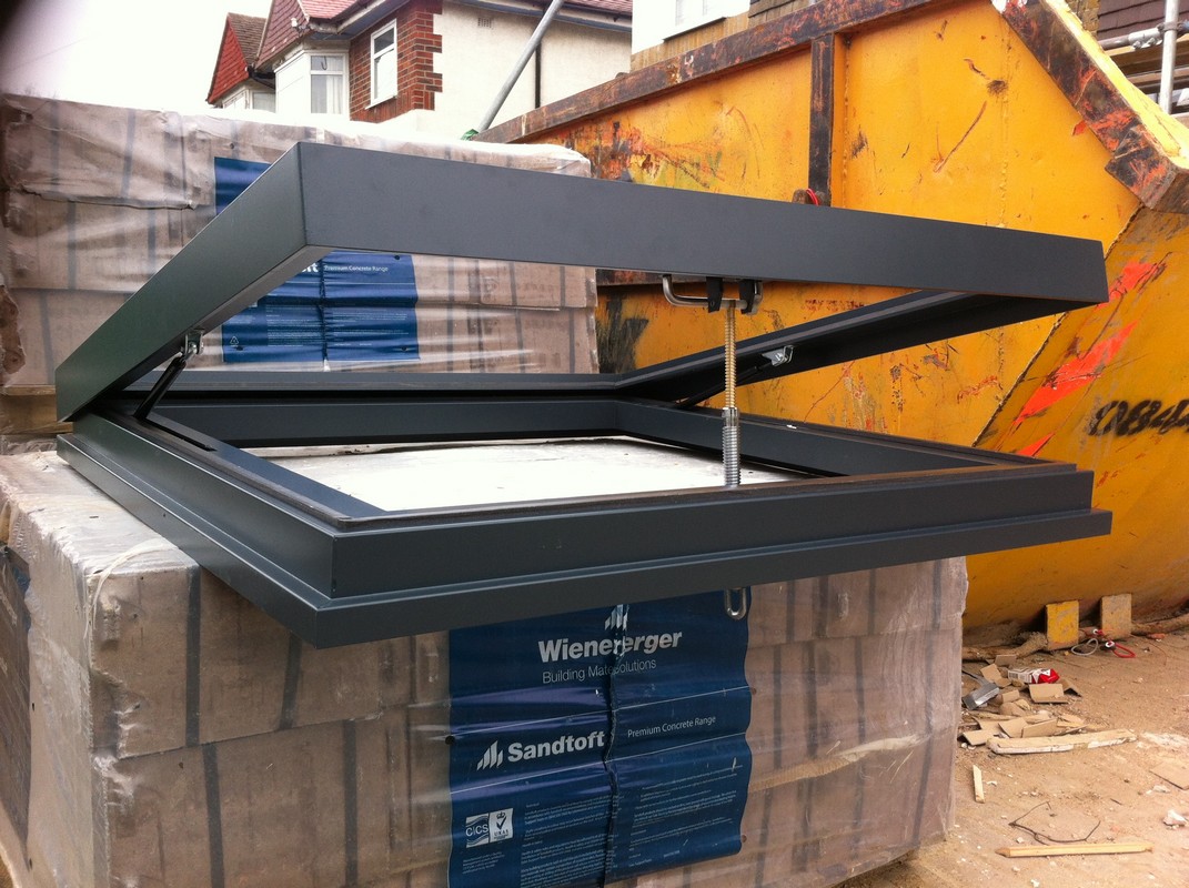 Opening flat roof skylight in anthracite grey installed in Kilburn