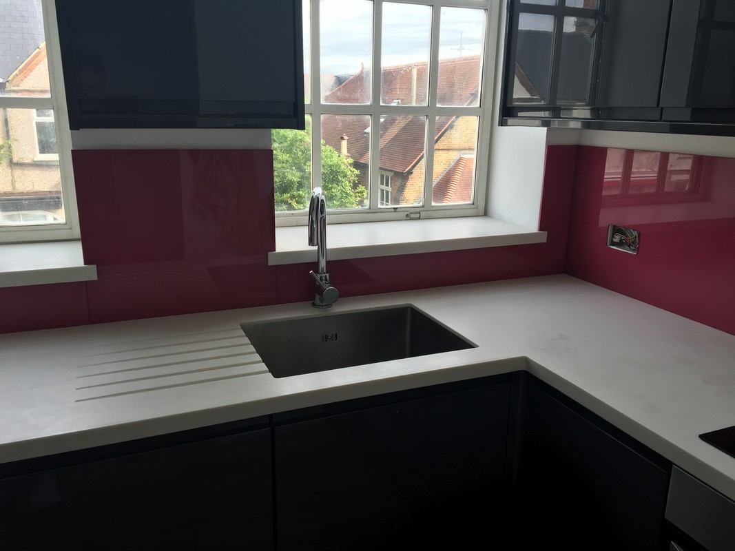 Deep plum coloured glass splashback in modern Kilburn kitchen